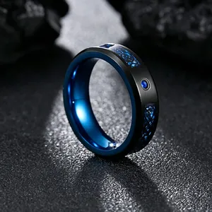 Macro detail of black and blue dragon pattern ring featuring blue cubic zirconia inlay