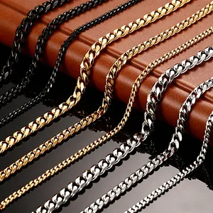 Detail view of Cuban link necklaces in gold, silver, and black stainless steel finishes.