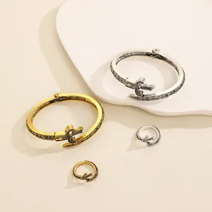 Detail view of vintage geometric sword design adjustable metal bracelet and ring set