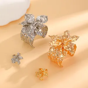 Elegant gold and silver textured metal flower cuff bracelets with matching rings