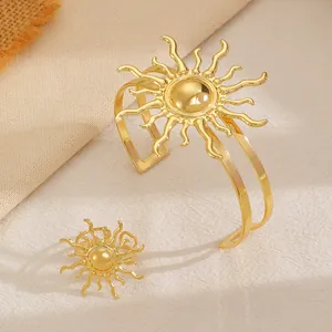 Detailed view of the gold sunburst geometric metal bracelet and ring set