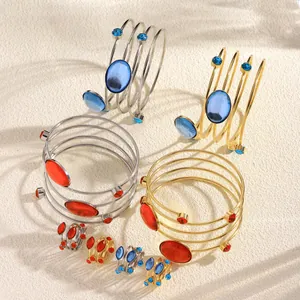 Detail view of geometric metal bangle and ring sets in gold and silver finishes