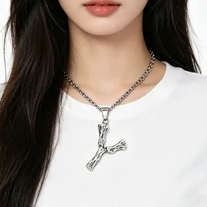 Close-up view of vintage textured letter Y pendant necklace on an Asian model