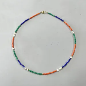 Detailed view of colorful seed beads and irregular freshwater pearl bohemian necklace