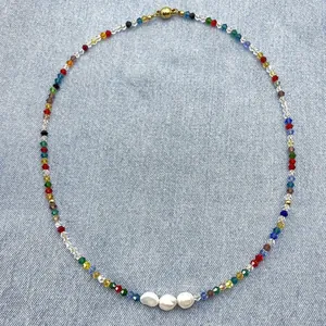 Detailed shot of Bohemian rainbow crystal beads with irregular white freshwater pearls