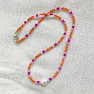 Close-up of bohemian dopamine style seed bead necklace with irregular freshwater pearl
