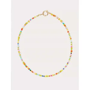 Macro detail of Bohemian rainbow seed bead necklace with gold spring ring clasp