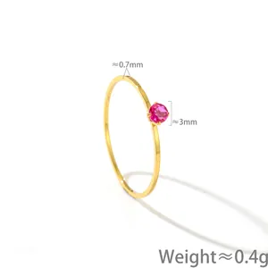 Detail view of a 14K gold minimalist thin ring with a 3mm pink gemstone, weight 0.4g.