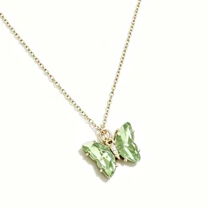 Elegante goldene Halskette mit einem brillant funkelnden grünen Kristall Schmetterlingsanhänger