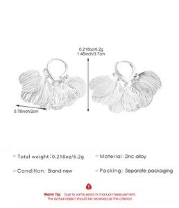 Detail showing silver hollow-out flower petal earrings with size specifications