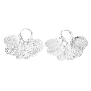 Detailed view of silver hoop earrings featuring elegant hollow line petal charms