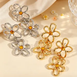 Elegante hohle Blumen-Ohrhänger in Gold und Silber mit bernsteinfarbenen Mitten