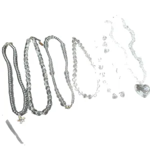 Minimalist set of clear beaded necklaces featuring heart and flower charms in various styles