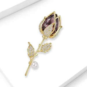 Detail showing a luxurious tulip brooch with purple crystal, pavé stones and a pearl