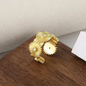 Close-up detail of a gold-plated adjustable daisy flower ring with zircon centers.