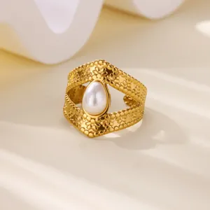 Detailed macro view of vintage stainless steel ring with teardrop faux pearl and hollow design
