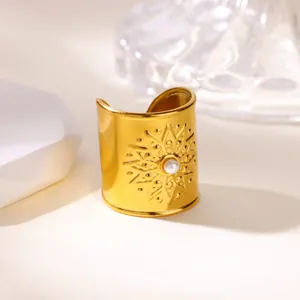 Detailed macro view of a vintage gold stainless steel cuff ring featuring a pearl sunburst design