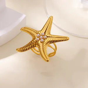 Close-up of a vintage golden stainless steel starfish ring with elegant pearls.