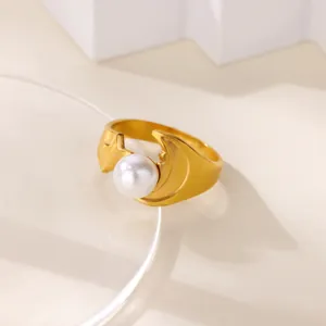 Detail shot of vintage style gold stainless steel ring with moon, star and pearl design