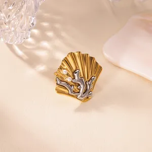 Detailed view of retro shell ring with silver coral and small pearls on gold band