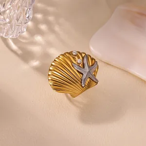 Close-up of vintage French shell ring with silver starfish and pearl accents