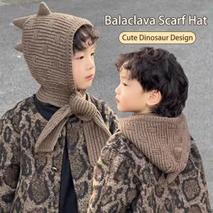 Dettaglio passamontagna in maglia per bambini con decoro dinosauro