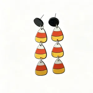 Detailed macro view of Halloween candy corn dangling earrings made from layered acrylic