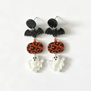 Detailed view of Halloween acrylic earrings with leopard pumpkin and ghost charms.