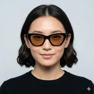 Stylish black cat-eye sunglasses with amber tinted lenses worn by a female model.