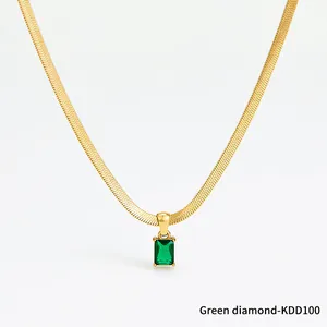Close-up of gold snake chain necklace with an emerald green square zircon pendant