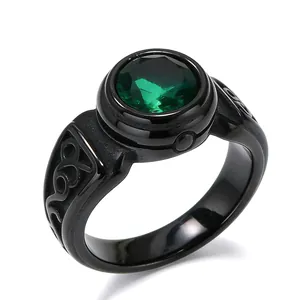 Close-up detail of a vintage black titanium steel ring featuring a large faceted green gemstone