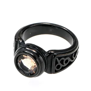 Detailed macro view of a vintage black titanium steel ring featuring a radiant champagne gemstone