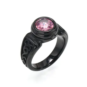 Close-up of a vintage black titanium steel ring featuring a vibrant pink gemstone centerpiece