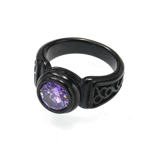 Detail view of a black titanium steel men's ring with a round purple gemstone.
