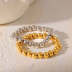 Detailed close-up of 18K gold and silver plated stainless steel beaded elastic bracelets