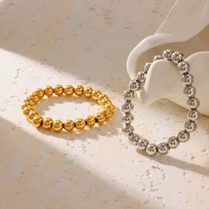 Close-up detail of 18K gold plated and silver stainless steel bead elastic bracelets