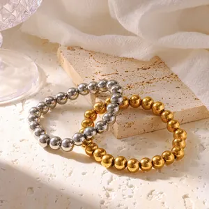 Macro detail of 18K gold and silver plated stainless steel bead elastic bracelets.