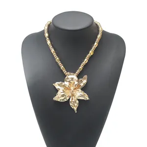 Detailed view of a gold-colored statement necklace featuring a large alloy flower pendant