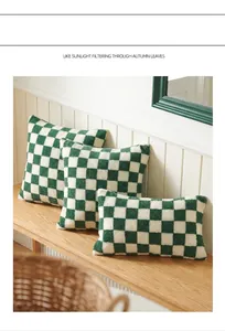 Close-up of green and white checkered lamb wool pillowcases on a wooden bench