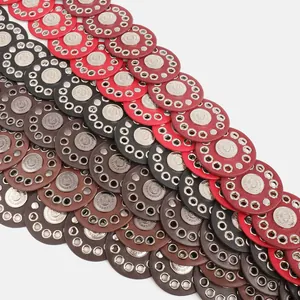 Detail of bohemian spliced disc belt with silver eyelets and studs.