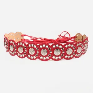 Red bohemian belt featuring stitched circular leather disks and silver conchos