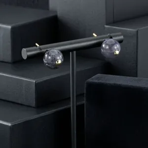 Macro view of elegant purple semi-precious stone earrings with refined gold-plated accents