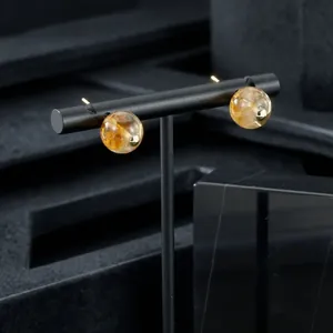 Amber-colored semi-precious stone bead earrings on professional black display stand