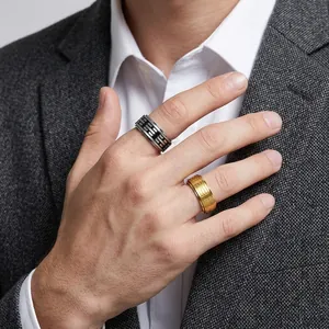 Close-up of rotatable titanium steel rings with Tai Chi pattern on male hand