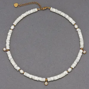 Dettaglio di una collana girocollo di perline in conchiglia naturale con ciondoli dorati