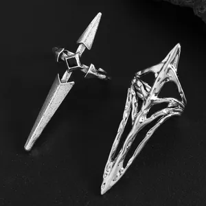 Detail of silver geometric nail rings with gothic dagger and hollow designs