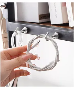 Heavy-duty silver metal magnetic hooks holding a white USB cable on a black metal shelf