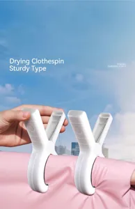 Strong windproof plastic clips securing a pink quilt against a blue sky backdrop.