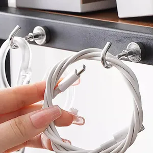 Strong silver magnetic metal hooks used for organizing USB charging cables on black metal shelves