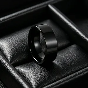 Professional studio shot of a polished black stainless steel wide band ring for men in a box